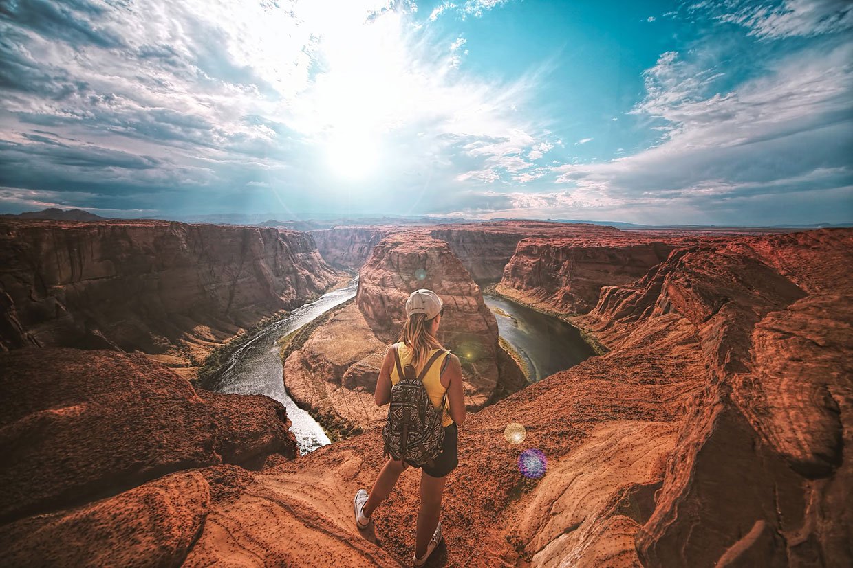 Curabitur lorem magna scelerisque a purus nec 2 Woman standing on top of canyon